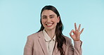 OK, sign and portrait of business woman with hand in gesture for yes, like or thank you on blue background in studio. Okay, emoji and expression for promotion, agreement and happy for success