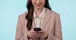 Phone, closeup and businesswoman in a studio typing a text message or networking on social media. Technology, communication and professional female model with cellphone isolated by blue background.