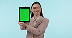 Tablet, green screen and smile with a business woman showing chromakey mockup on a blue background in studio. Technology, app and a happy young employee with tracking markers on a screen or display