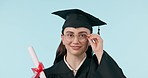 Graduation diploma, glasses and happy woman wink for university education, school or college success. Learning achievement, studio certificate scroll and portrait of student flirt on blue background