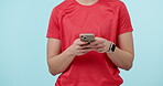 Hands, phone and social media with a person typing a text message closeup on a blue background. Mobile, contact and app with an adult in studio to search the internet for information or networking