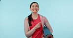 Pointing finger, fitness and portrait a woman in studio for advertising, announcement or mockup. Face of happy young female person on a blue background for excited choice, hand sign and exercise mat