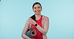 Fitness, pointing finger and portrait a woman in studio for advertising, announcement or mockup. Face of happy young female person on a blue background for health choice, hand sign and exercise mat