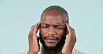 Headache, black man and face in studio with pain and burnout from corporate job and mental health. Businessman, person and stress with anxiety and brain fog from audit career on blue background
