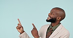 Happy, pointing finger, and a business man in studio for advertising, announcement and mockup space. Information, corporate and a professional african person from Kenya on blue background for choice