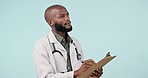 Black man, doctor and writing on clipboard, thinking or planning with checklist against a studio background. African male person, medical or healthcare worker taking notes for inspection on mockup