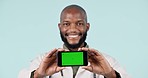 Green screen, phone and doctor with face of black man in studio for medical, digital and website. Medicine, healthcare and technology with portrait of person blue background for presentation and app