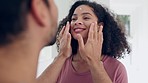 Love, face cream and couple doing skincare in the bathroom together for wellness, health and bonding. Self care, happy and young man and woman doing facial treatment with lotion in modern apartment. 