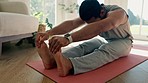 Man, yoga and stretching for home meditation, fitness and holistic training on living room floor with healing energy. Calm, peace and young person with pilates exercise and legs or muscle wellness