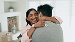 Keys, hug and a couple celebrate a new home, moving in together or renting real estate property. A happy man and woman kiss, success and excited for first house with mortgage, boxes and investment 