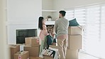 Couple, new house and boxes for moving, living room planning and painting or ideas for property or real estate. Happy interracial people unboxing cardboard and furniture for home, lounge or apartment