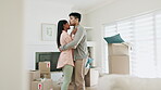 Couple, dancing and hug to celebrate new home or moving in together with real estate property. A happy man and woman dancer with love in their first house with mortgage, boxes and investment 