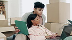 Couple, tablet and laptop in real estate discussion, new home or moving in with boxes in property together. Man and woman homeowners on technology in planning, renovation or relocation plan at house