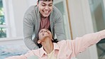 Real estate, box and a couple playing in their new home as a celebration of success in mortgage, bond or loan approval. Love, property or investment with a man and woman having fun while moving house