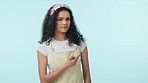 Frown, doubt and a confused woman pointing to mockup on a blue background in studio for marketing. Portrait, space and hand gesture of a young person showing information or a menu for advertising