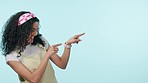 Pointing, attention gesture and a woman on a blue background for communication, excited and conversation. Calling, happy and a young girl or person with discussion and speaking on a mockup backdrop