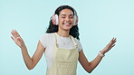 Dancing, music and happy woman on headphones in studio isolated on a blue background mockup space. Radio, smile and person moving to audio, listening to sound and hearing hip hop, podcast and freedom