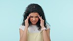 Woman, headache and depression in studio for stress, vertigo or brain fog on blue background. Frustrated, confused and sad model in pain, anxiety and thinking of mistake, debt crisis or mental health