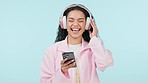 Dance music, phone and happy woman on headphones in studio isolated on blue background mockup space. Radio, person with mobile moving to audio or listening to sound, hearing for freedom or streaming