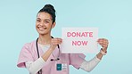 Donate, sign and face of woman with nurse smile and poster for blood, organ of healthcare donation in studio. Help, charity work and person portrait with clinic and hospital billboard for advertising