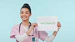 Health, vaccine poster and woman nurse with advice or promo for vaccination, safety from virus on blue background. Medical choice, show sign and immunization with protection and healthcare in studio
