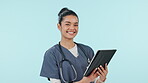 Doctor, happy woman and tablet for healthcare service, planning clinic schedule and research or data in studio. Face of medical student or nurse smile for digital tech and website on blue background