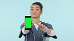 Woman, doctor and pointing to phone with green screen or mockup in advertising against a studio background. Portrait of serious female person or medical nurse showing mobile smartphone app or display