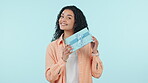 Shake box, excited or happy woman in studio isolated on a blue background with box or product. Face, guess or person with present for party, celebration of holiday or birthday package for giveaway