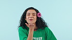 Woman, happiness and blowing a kiss in studio as a volunteer at charity event or ngo on blue background. Mockup, portrait and hand gesture for love, community and crazy girl with creative hair