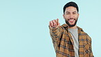Hand, pointing and man with recruitment of you in college, opportunity or club with a smile on face for yes or decision on blue background. Student, accountability and gesture to show a choice