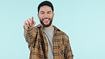 Pointing, hand and man with recruitment of you in college, opportunity or invitation with a smile on face for decision on blue background. Student, accountability or gesture to show person a choice