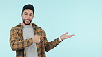 Show, mockup or happy man in studio by discount deal or sale on menu space for advertising. Face, announcement or person pointing to choice for guide option, news or offer on blue background for logo