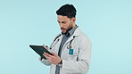 Doctor, healthcare and tablet for surgery planning, research or online consulting in studio on blue background. Telehealth, professional worker and person with digital tech for patient analysis