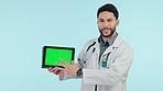 Doctor, tablet green screen and presentation, talking of healthcare information, advice or consulting in studio. Face of medical worker on digital mockup, software and speaking on a blue background
