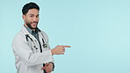 Man, doctor and pointing on mockup space in advertising or marketing against a studio background. Happy male person, medical or healthcare professional show notification alert, help or health advice