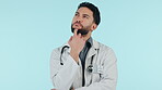 Medical doctor, thinking and a man in studio for problem solving, solution or medicine choice. Serious, face and arab healthcare worker on blue background for decision, doubt or question about future