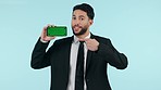 Business man, phone green screen and presentation, website sign up information and advertising in studio. Face of professional on mobile mockup, pointing you and tracking marker on a blue background