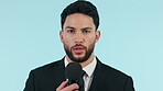 Face, man and news reporter speaking on microphone in studio isolated on a blue background mockup space. Portrait, journalist and anchor on live broadcast, media communication and speech of tv host
