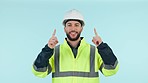 Studio architect, construction worker or happy man pointing up at engineering design, commercial news or advertising. Engineer portrait, project announcement or architecture promotion blue background