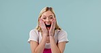 Surprise, wow and face of woman on blue background for good news, announcement and winning. Excited, omg and portrait of person in studio in happy, joy and cheerful facial expression for celebration