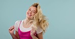 Young woman, excited and happy dance, fun and freedom with jump for joy isolated on blue background. Shake hair, energy and mockup space, portrait and celebration with winner and cheers in studio