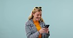 Surprise, excited and woman on blue background with phone for announcement, achievement and news. Winner, success and happy person on smartphone for winning bonus, promotion and prize in studio