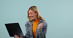 Woman, student and winner on laptop for university success, college results or funding opportunity in studio. Young person yes, fist and celebration on computer for education news on blue background