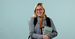 Woman, student and nerd in glasses with books, science and smile in portrait with learning on blue background. Excited, happy and education, knowledge at university with textbook and study in studio