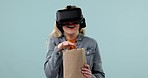 Virtual reality, woman and popcorn, funny video with 3D experience, metaverse and future technology on blue background. Corn snack, comedy film and software, mockup space and digital world in studio