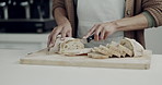Bakery, food and bread with hands of person in kitchen for cooking, health and grain. Wellness, baker and flour with closeup of man cutting with knife on table at home for chef, nutrition and diet