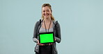 Personal trainer, fitness and woman with green screen on tablet with mockup for website in studio. Portrait of happy person or coach for exercise plan with technology announcement on blue background