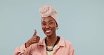Black woman, thumbs up and review, face and agreement with support and smile on blue background. Feedback, like emoji and yes in studio, portrait with success and hand gesture, thanks and promo