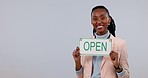 Black woman, small business and open sign pointing on mockup space against a studio background. Portrait of happy African female person smile and showing billboard or poster in ready for service