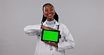 Happy black woman, doctor and tablet with green screen in advertising against a studio background. Portrait of African female person, medical or healthcare showing technology display, app or mockup